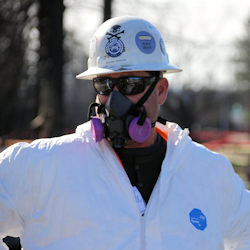 worker in contaminated PPE
