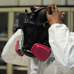 worker putting on respirator