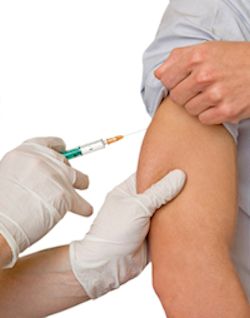 Nurse giving a patient the hepatitis B shot.