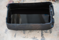 This oblong tub is a makeshift container filled with solvent