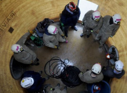 Workers inside a very large confined space