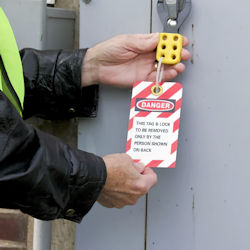 worker using lock out tag out on door handle