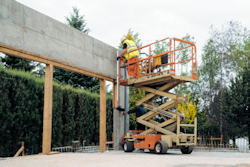 worker on a scissor lift with a clean and organized platform.