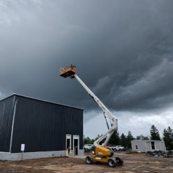 Aerial lift next to building in cloudy stormy weather.