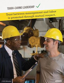 Image of a tough caring leader looking an employee in the eye with his hand on the employees shoulder.