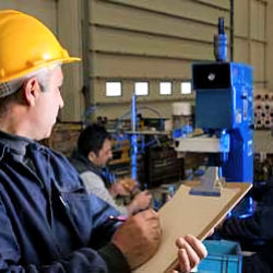Inspector observing employee at work