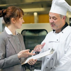 Image of trainer and learner concluding and documenting a training session