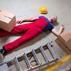 worker laying on floor that has fallen off ladder