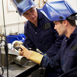 Image of two employees conducting show and tell on the job training