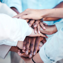 Safety committee all stacking hands together as a sign of unity