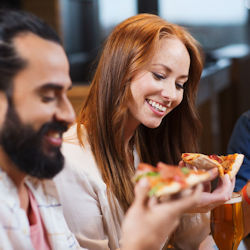 Two safety committee members eating pizza