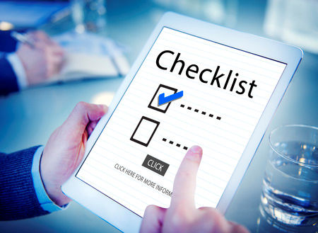 Employee holding a computer tablet reminding them of their checklist