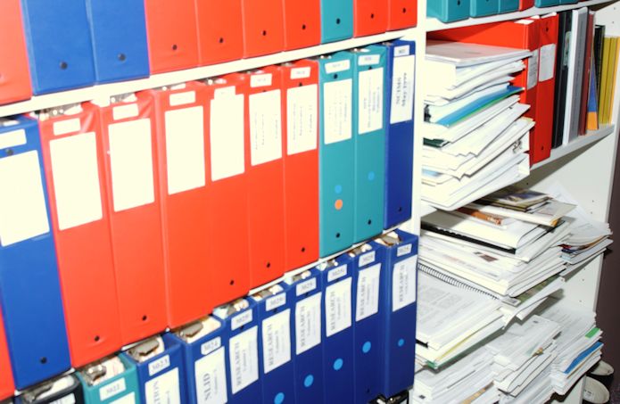 bookshelves of notebooks and papers