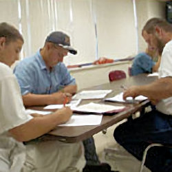 Four workers sitting at a table studying