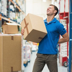 Worker using hand on painful back holding box.