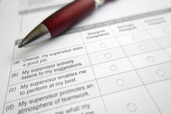 survey form laying on a desk with a pen