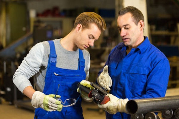 Two employees inspecting a hand tool