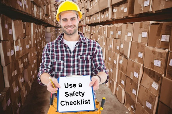 Happy employee holding a safety checklist notebook