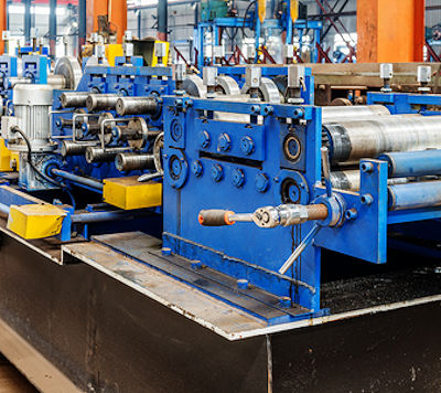 Large equipment with multiple moving parts on work table.