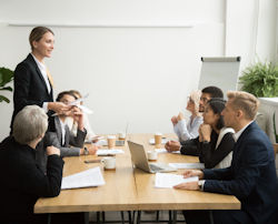 Leader presenting information to a group in a meeting