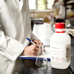 Lab workers checking chemical container