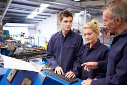 Three workers inside preparing for a job hazard analysis