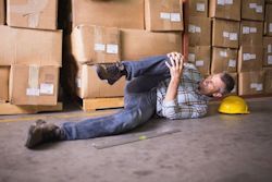 Employee laying on floor with knee injury