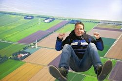 Man high over fields sky diving