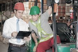 Two employees reviewing the steps of a task
