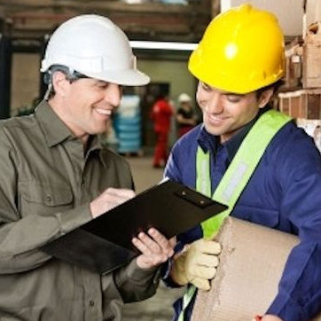 Two employees reviewing a JHA Job Hazard Analysis.