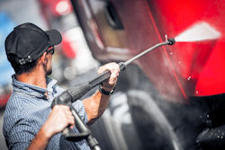 Worker washing a truck