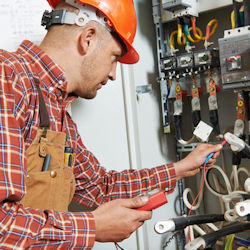 Employee testing equipment after lockout tagout operations.
