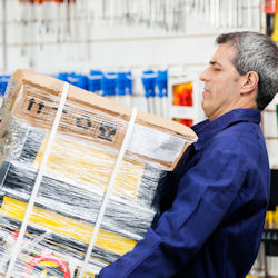 worker carrying heavy package