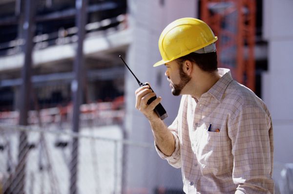 worker using hand-held device for communication