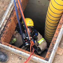 Worker practicing self rescue from a confined space.