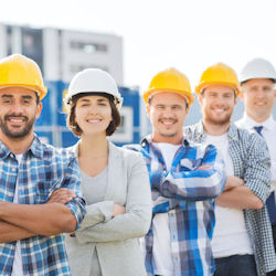 Five happy employees standing in a row