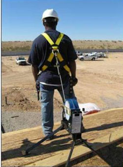 Worker on roof with self-retracting lifeline system