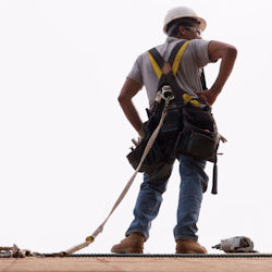 worker with fall protection standing on roof