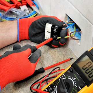 Electrician wearing protective gloves while working.