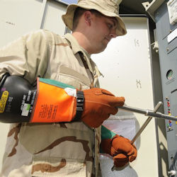 Electrician wearing electrical protective gloves over insulating gloves.