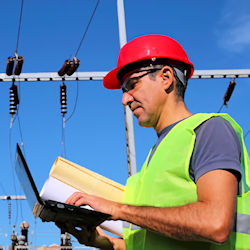 worker inspecting high voltage system