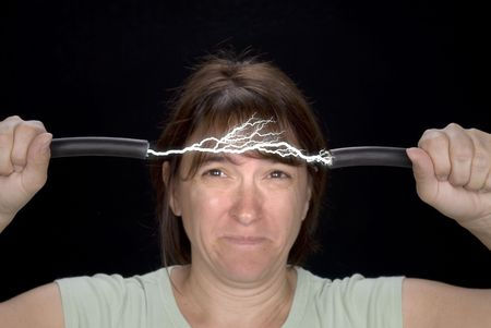 Worker stretching broken electrical cord across forehead