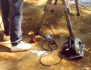 This worker has multiple electrical hazards at his feet