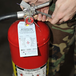 Worker inspecting extinguisher