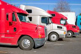 Three big rigs parked in a row.