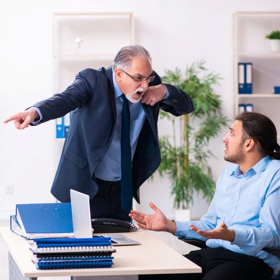 Image of a supervisor yelling at employee at desk