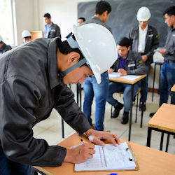 Worker signing an attendance roster