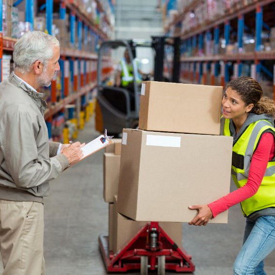 Image of ergonomics specialist observing employee lifting boxes
