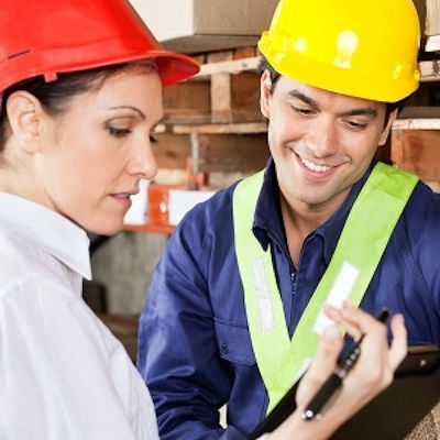 two employees reviewing a job hazard analysis.