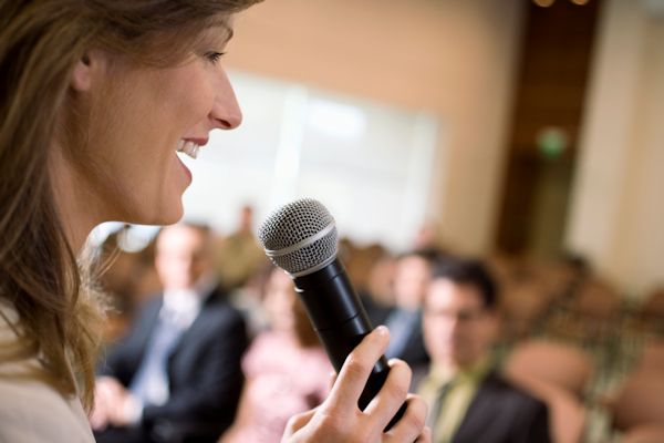Image of a trainer with microphone presenting training